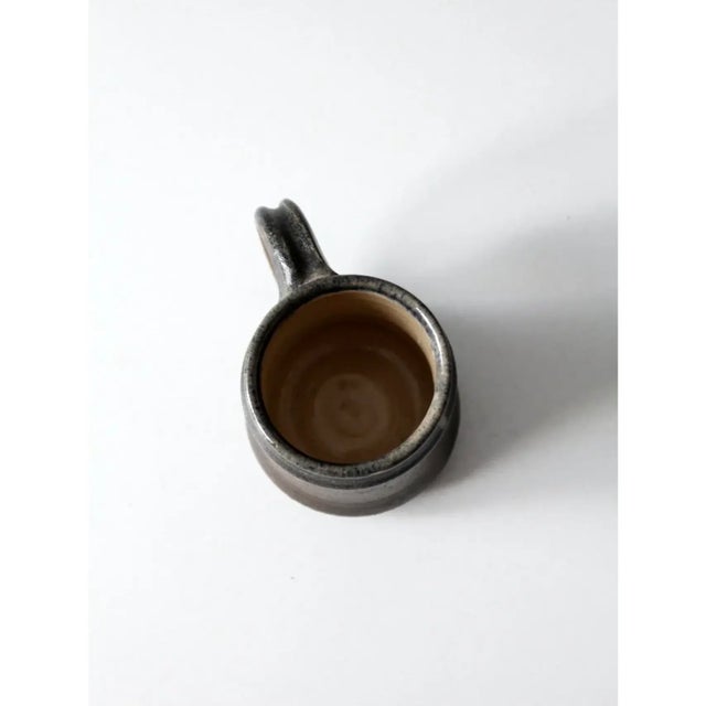 Vintage studio pottery mug, hand-crafted and signed by the artist, featuring a striking brown, black, and gray glaze with...