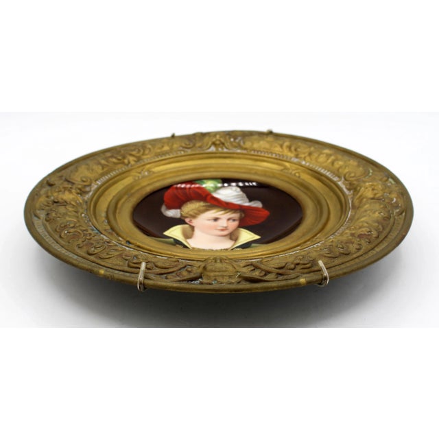 Circa 1870-1900 porcelain painted plaque in brass holder, Continental. Renaissance revival. Charmingly hand painted of a...