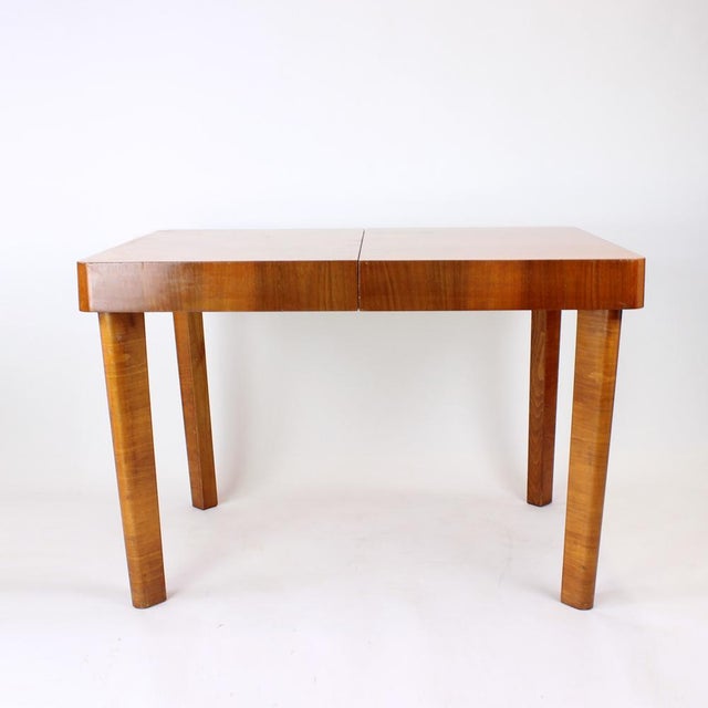 A striking and highly collectible dining table produced by Tatra in the 1950s, showcasing the elegance and innovation of...