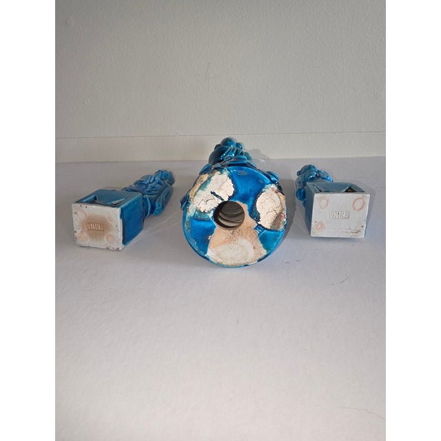 Three Turquoise color Chinese porcelain figures. The larger one appears to be older than the two smaller ones. These are...