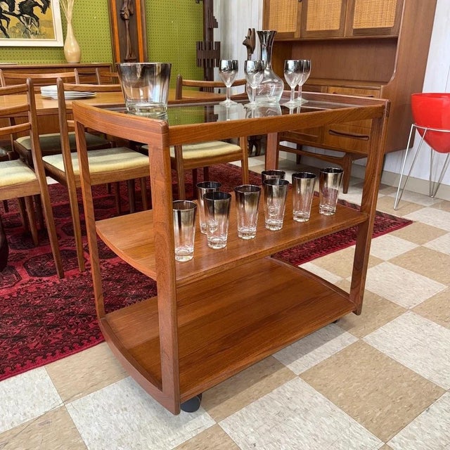 Vintage mid-century modern solid Afromosia and glass serving trolley or drinks cart manufactured by Meredew of Letchworth...