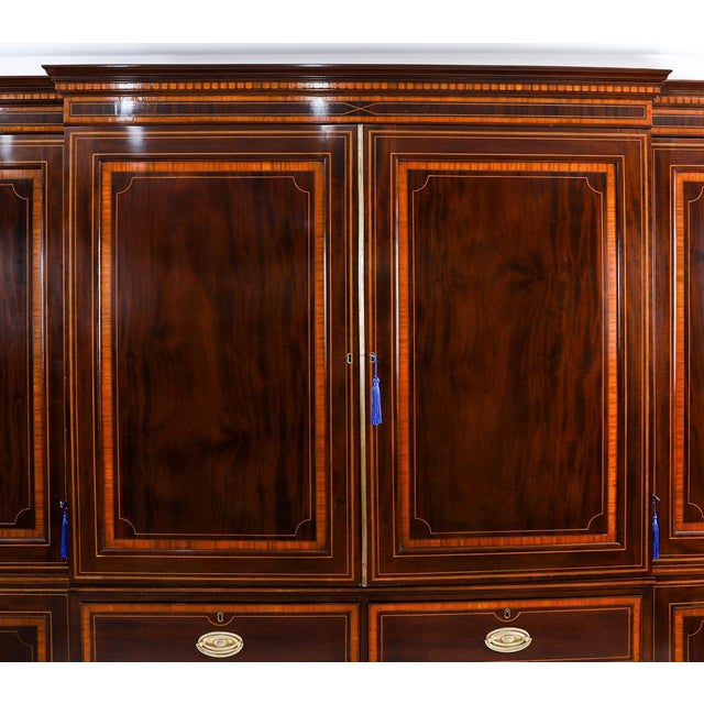 This is an impressive antique george iii flame mahogany, satin wood banded, boxwood and ebony strung breakfront wardrobe...