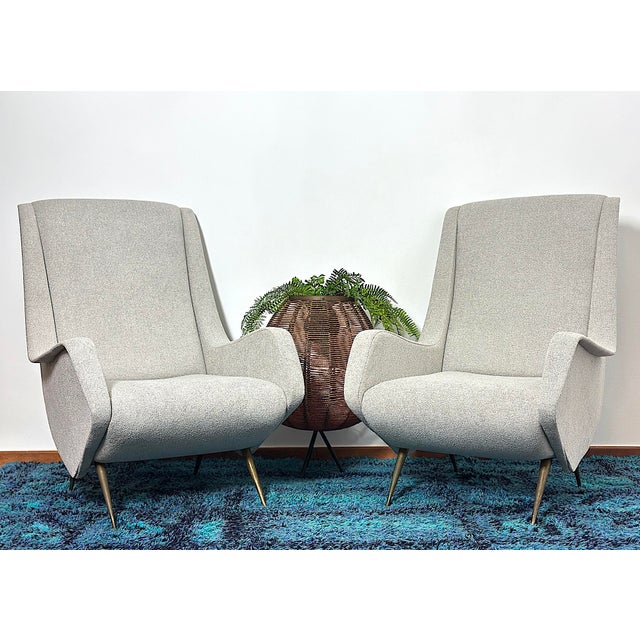 Pair of vintage armchairs from the 1950s with an elegant and distinctive profile, designed by italian designer aldo...