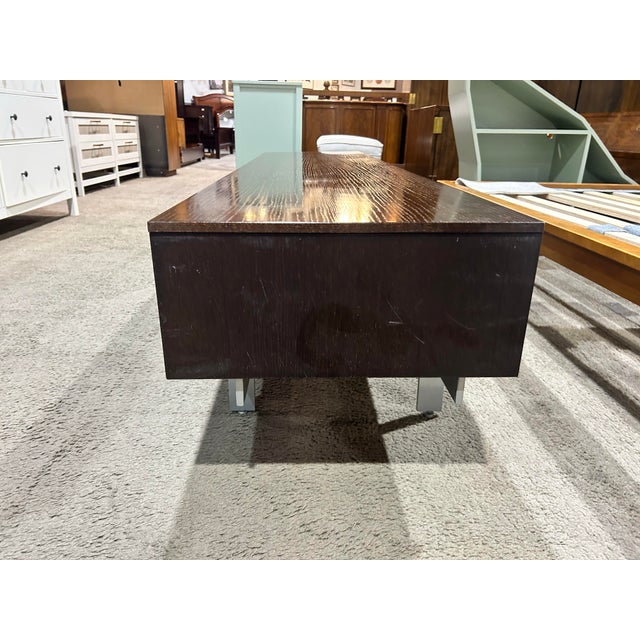 Elevate your space with this dark wood credenza featuring stylish louvered front drawers that blend timeless craftsmanship...