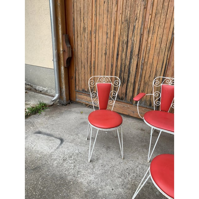 This is a metal framed garden set from the 1960s. White metal and red leatherette. Two chairs, one 2-seater bench and one...