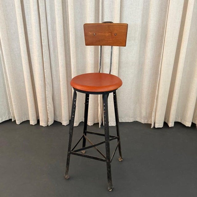 This tall, industrial train station switchboard operator stool was manufactured by the Angle Steel Stool Co. The maker's...