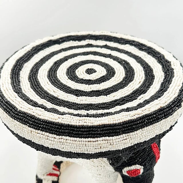 This striking black and white beaded Bamileke stool is a true statement piece, blending traditional African craftsmanship...