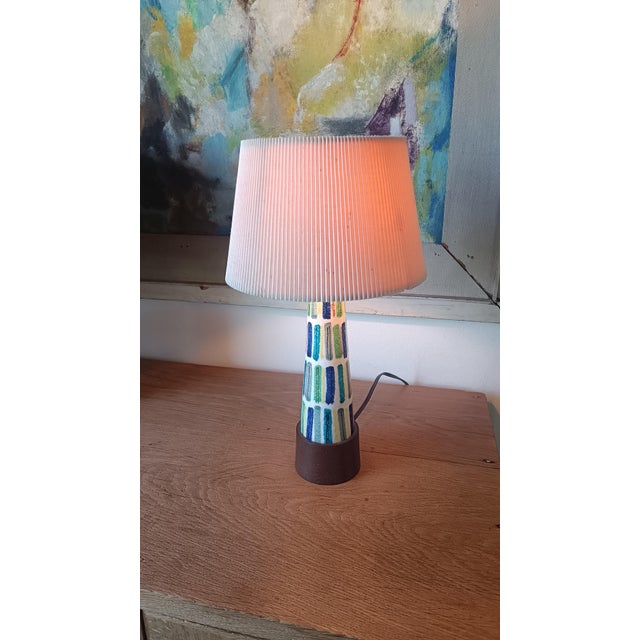 Lovely and unique Alvino Bagni small table lamp from the late 1950s. Playful bright colors. The original wooden foot makes...