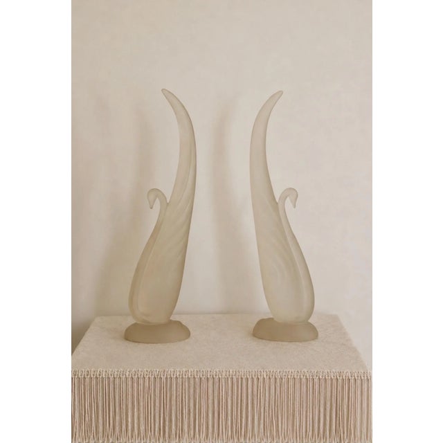 A graceful pair of Austin Sculpture frosted art glass swans featuring elegant elongated necks and flowing organic forms....