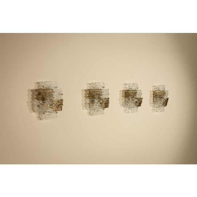 A sculptural interplay of glass, texture and light defines this rare set of four wall lamps by Zero Quattro, produced in...
