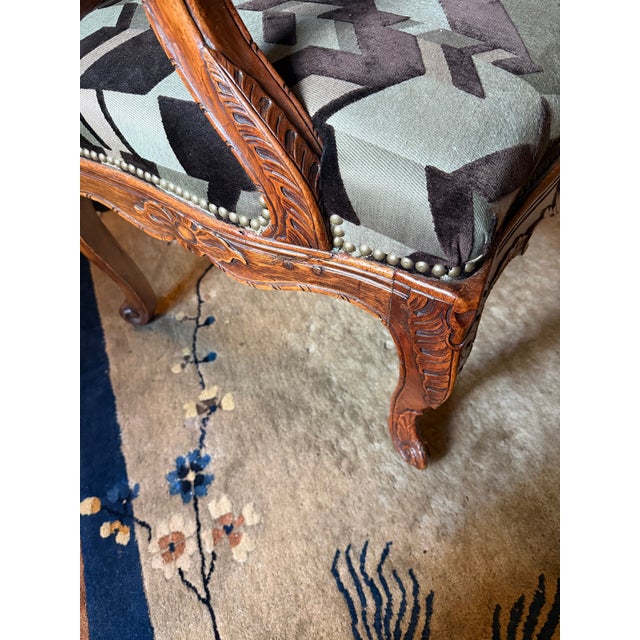 I bought this lovely chair at an auction in Los Angeles several years ago. I never thought it was old and don't know...