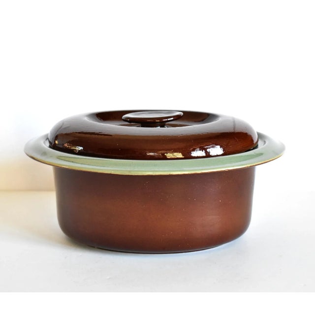 A vintage Red Wing Pottery "Oomph" pattern casserole covered baking and serving dish of heavy stoneware ceramics, in a...