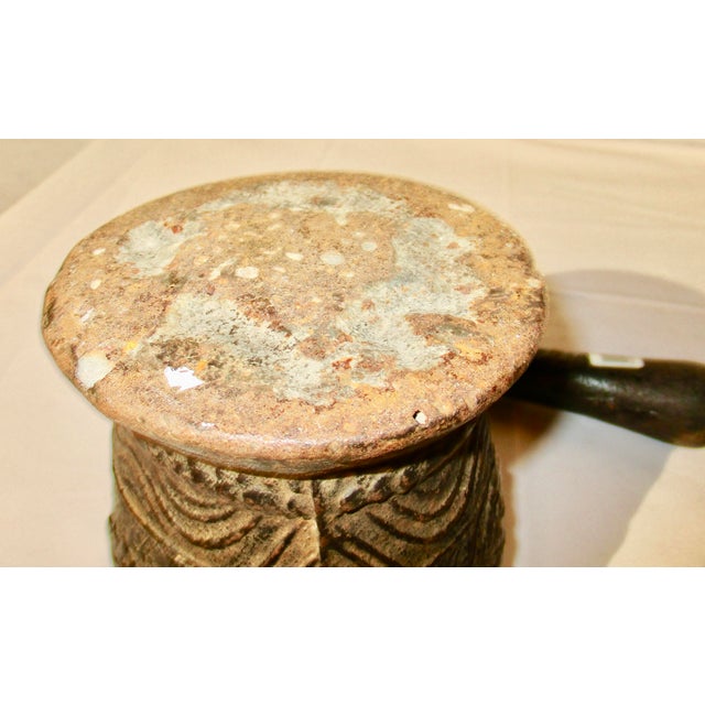 Antique cast Iron mortar and cast iron pestle for grinding powders from grains or herbs. Surface design is simple: floral...
