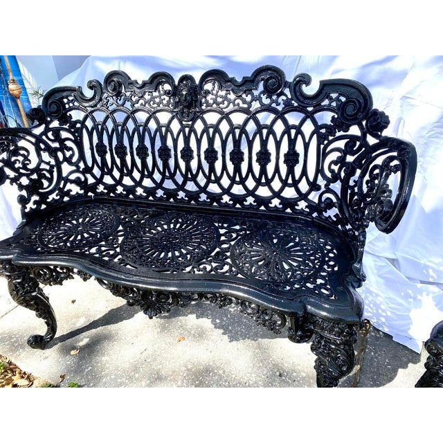 A striking pair of cast-iron garden seats in the Victorian "Betsy Ross" pattern, featuring the signature maiden-face...