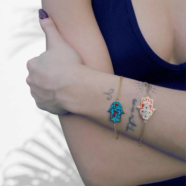 This elegant Red Enamel Floral Hamsa Hand Gold Vermeil Chain Bracelet features a double chain design, crafted from...