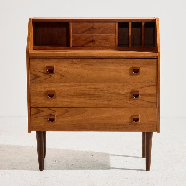 Danish teak bureau desk in restored condition with five drawers and extendable writing board from the 1960s. The furniture...