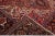 Beautiful antique Heriz hand-knotted wool rug with a red field. This Persian rug has a navy-blue designed frame and...