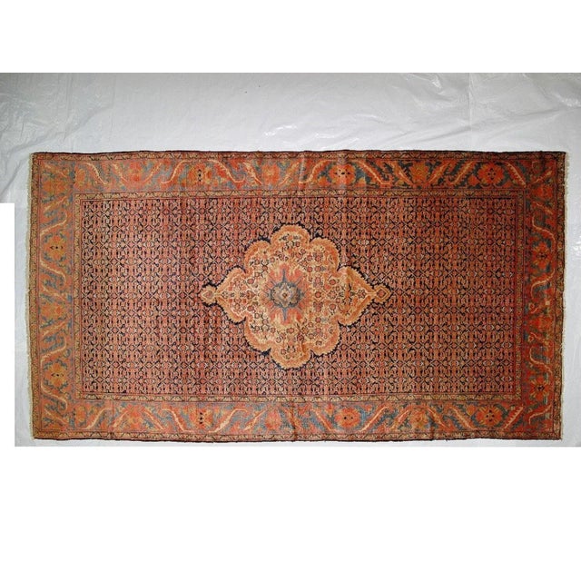 This masterpiece is a wool pile genuine handwoven antique Persian Ferahan rug. The piece is in excellent condition.