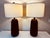 Pair of vintage high-end wooden table lamps with a sculptural, modern design. Each lamp features a rich dark wood with...