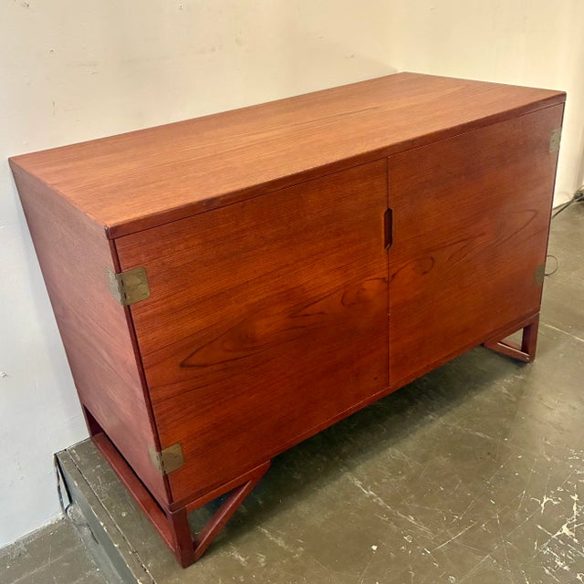 Svend Langkilde petite cabinet for Illums Bolighus. Produced by Langkilde Mobler, Denmark 1960’s. The teak wood grain is...