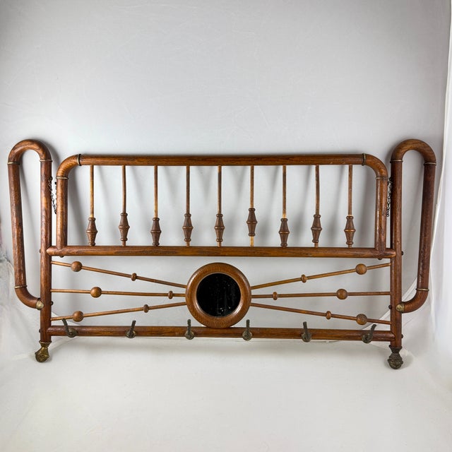 From the Belle Epoque Era, a hanging and folding Bentwood Oak and Brass coat and hat rack, France, circa 1880-1900. A...