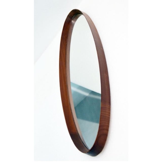 Oval mirror with a wooden frame from the 1950s. Distinctive wooden frame shaped into a sloping triangle. In excellent...