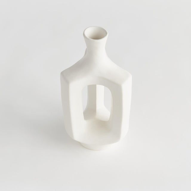 Simple and wide open in form with a matteWhite glaze, this decorative vase is a truly modern accent. Perfect for a single...