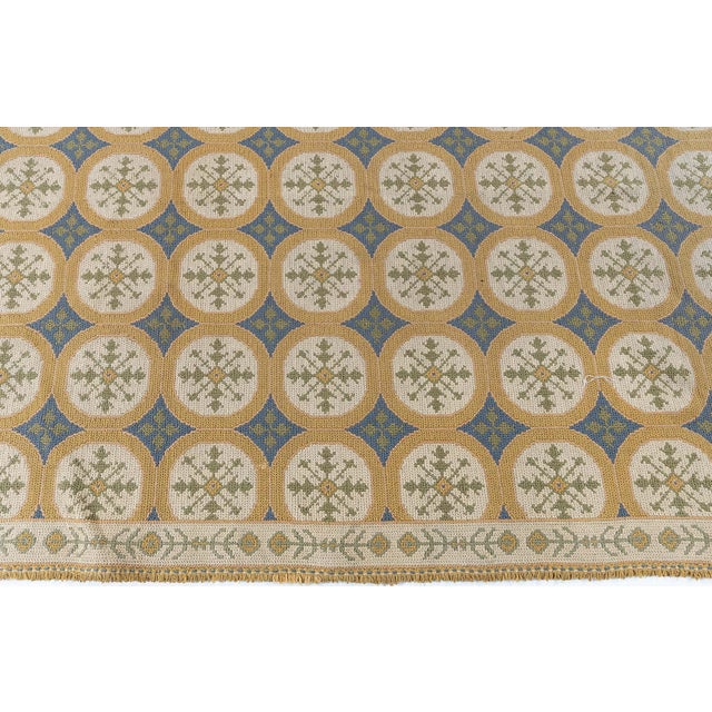 This charming 1940s Portuguese needlepoint rug reflects the distinctive craftsmanship and decorative spirit of traditional...