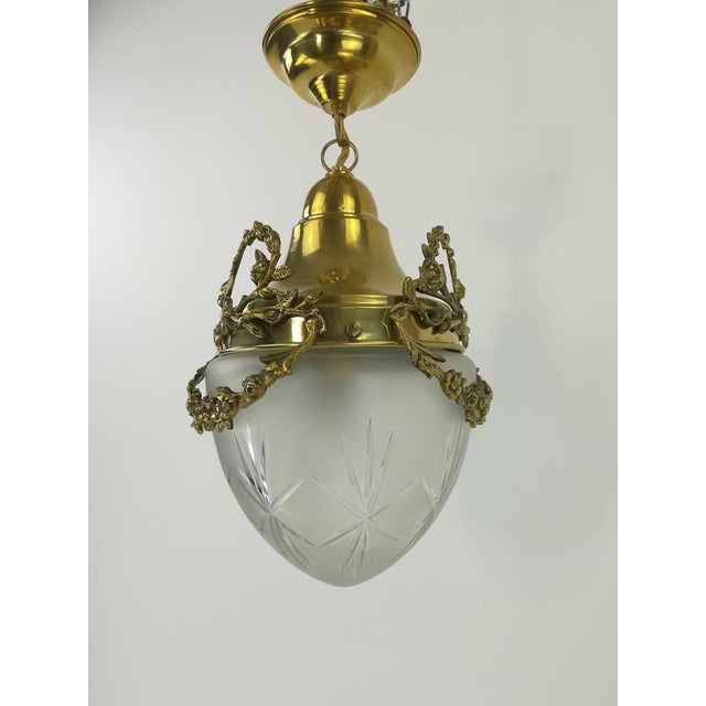 Polished brass lamp for the ceiling from France. The glass is oral -blown and hand -ground from the time. The lamp gives a...