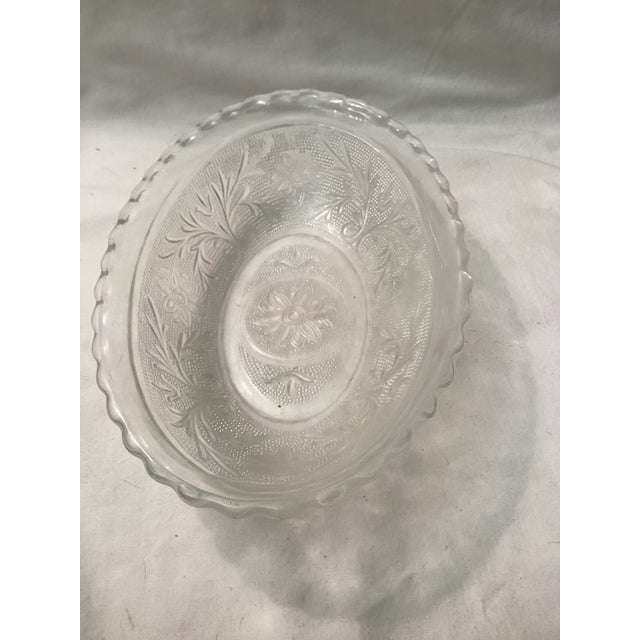 This vintage oval serving both features, a delicate floral pattern pressed into clear glass, surrounded by a textured...