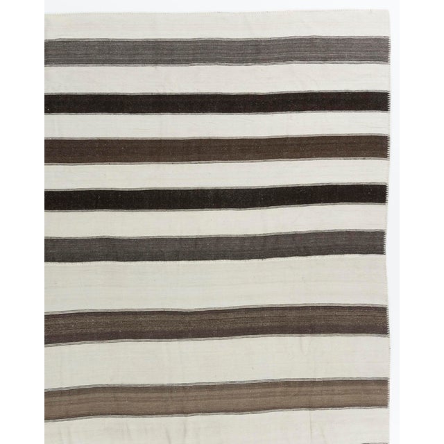 This vintage Turkish flat weave Kilim, hand-woven exemplifies timeless design with its simplicity and boldness, making it...