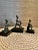 A trio of bronze figures from the Fon people of Benin. Elements from a larger shrine for the focus of veneration to...