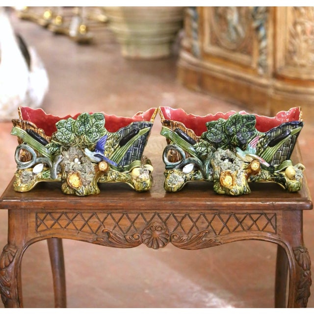 Crafted in France circa 1890, this remarkable pair of antique majolica jardinières exemplifies the naturalistic barbotine...