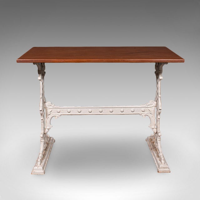 This is an antique orangery planting table. An English, mahogany and cast iron portico or serving table, dating to the...