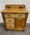 This is an antique late Victorian Eastlake-style washstand or commode in golden oak, dating to approximately 1890–1910. It...