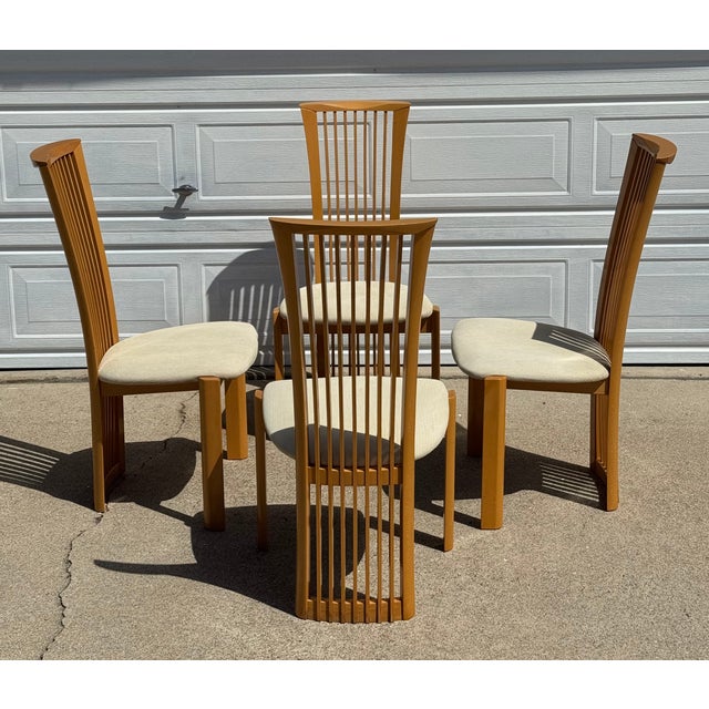 A set of 4 sculptural and functional late 20th century postmodern Italian high-back dining chairs by Pietro Constantini....