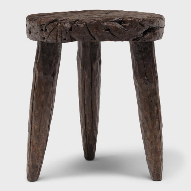 The round top of this rustic, tri-leg side table is an antique wooden wheel, repurposed from an early 20th century ox-...