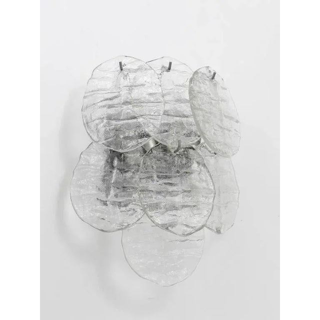 A beautiful Austrian wall light, model "Blatt", executed by Kalmar Vienna in the 1960s. Seven leaf-shaped ice glass discs...