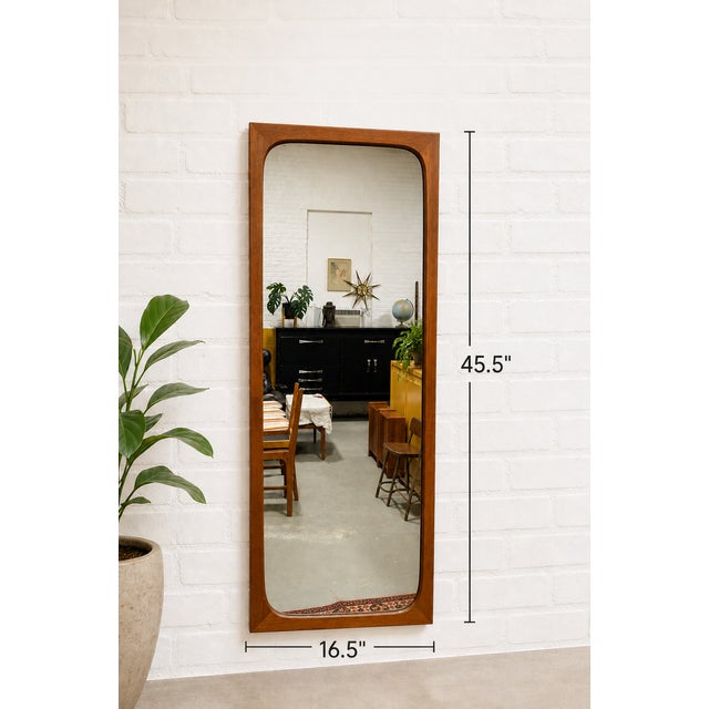 Mid Century Modern Danish solid teak mirror by Aksel Kjersgaard, circa 1960s. Streamlined teak frame and crystal clear...