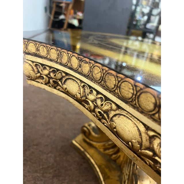 Gilt gold style Hollywood regency side table in an interesting shape. Small flaw on top, see pictures.
