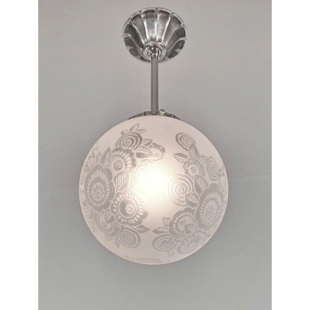 Etablissements Leune - Auguste Heiligenstein A French art deco pendant light made circa 1925-1935. A nickel plated bronze...