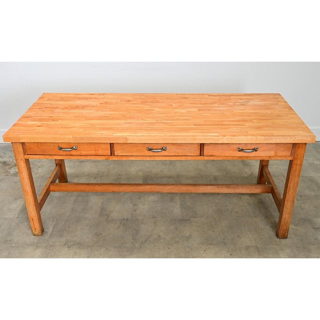 A unique butcher-block top table from 19th century France, that deftly navigates the demands of a kitchen or farm, to...