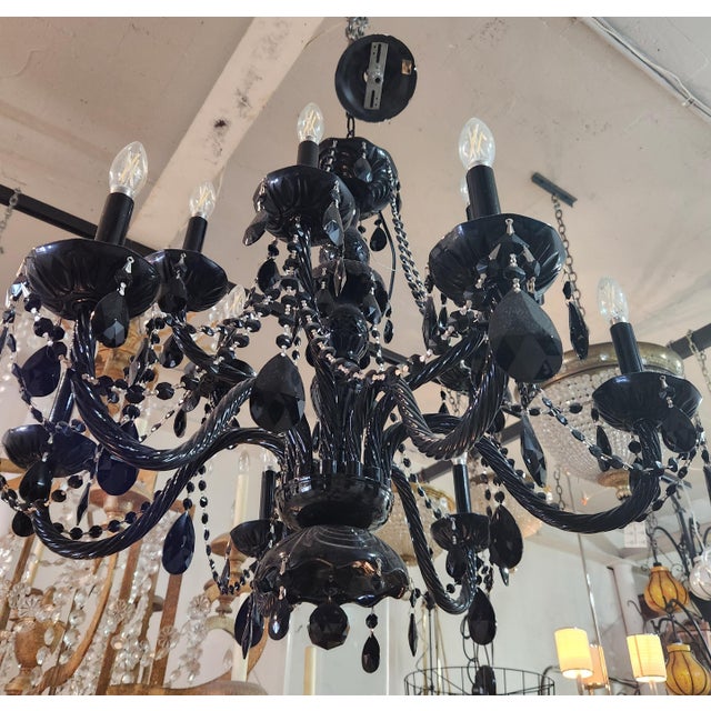Black glass chandelier. It has two tiers, total of 12 light, twisted glass arms with black beads chain & black crystal...
