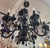 Black glass chandelier. It has two tiers, total of 12 light, twisted glass arms with black beads chain & black crystal...