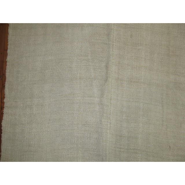 One of a kind vintage Turkish kilim in white from the third quarter of the 20th century. Sturdy, versatile. and chic. One...