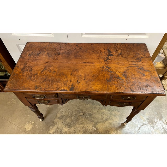 Antique writing desk or vanity. Burl wood top and drawer fronts. All original hardware and wheels. Dovetail joint...