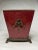 A beautiful rich, mottled ruby and crimson red to cinnabar color adorns the ceramic and brass jardiniere. The piece is in...