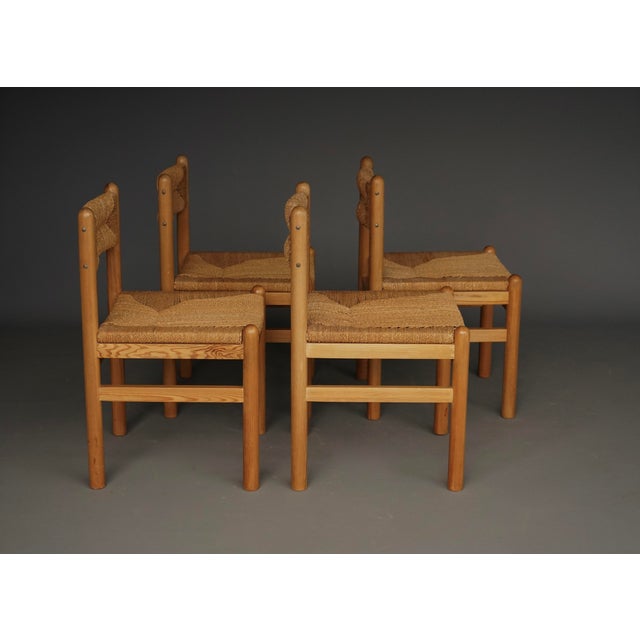 A stylish set of four possibly Danish chairs designed in the manner of Charlotte Perriand. Minimalist pine frames and...