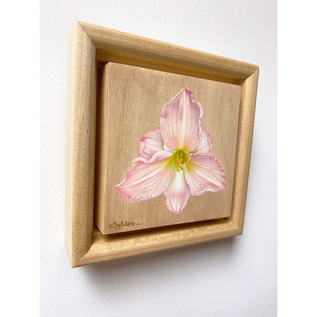 This oil painting depicts a delicate Hemerocallis flower, capturing its soft pink hues and intricate petal details against...