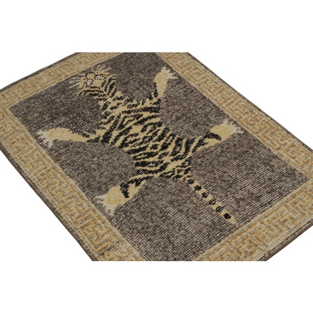 Hand-knotted in wool, this 2x3 modern tiger pictorial rug features a vibrant colorway of gray, beige and black tones. On...